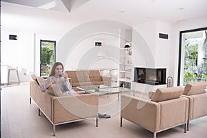 Young woman in a bathrobe enjoying morning coffee