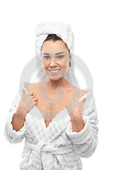 Young woman in a bathrobe and towel on her head