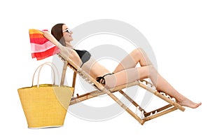 Young woman with beach accessories on sun  against white background