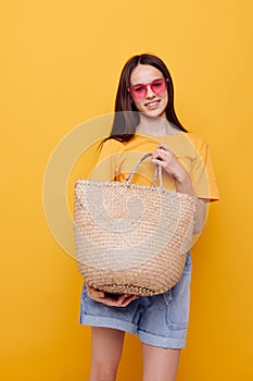 young woman Beach bag fashion in yellow t-shirt denim shorts Lifestyle unaltered