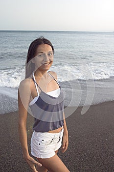 Young woman on the beach in very positive and happy attitude photo