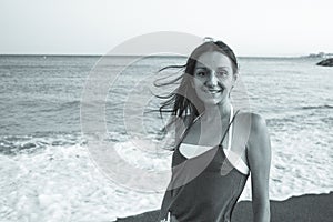 Young woman on the beach in very positive and happy attitude photo