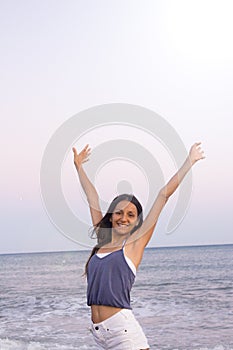 Young woman on the beach in very positive and happy attitude photo