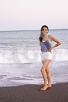 Young woman on the beach in very positive and happy attitude photo