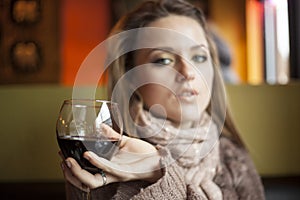 Young Woman with Beautiful Blue Eyes Drinking Red Wine