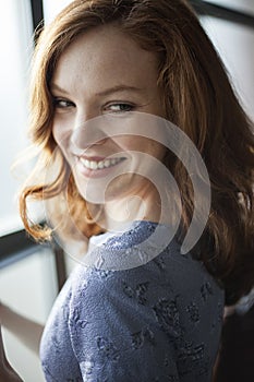 Young Woman with Beautiful Blue Eyes and Red Hair