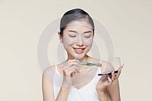 Young woman with beautiful eyeshadows on color background