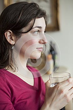 Young Woman with Beautiful Green Eyes Drinking Water