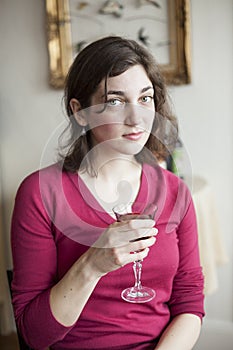 Young Woman with Beautiful Green Eyes Drinking Wine