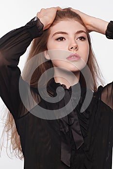 Young woman with a beautiful hair in black blouse