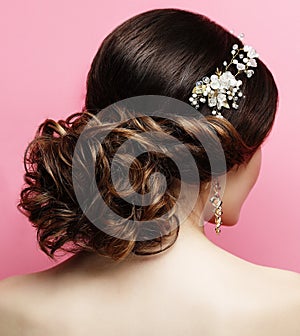 Young woman with beautiful hairstyle and stylish hair accessory