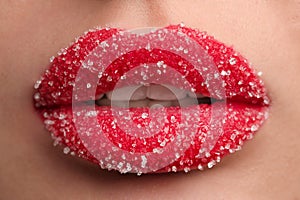 Young woman with beautiful lips covered in sugar, closeup