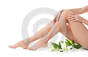 Young woman with beautiful long legs on white background