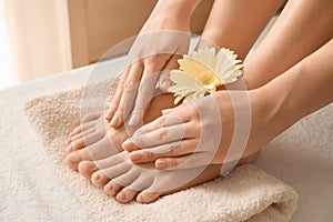 Young woman with beautiful pedicure and manicure after treatment in spa salon