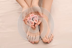 Young woman with beautiful pedicure and manicure after treatment in spa salon