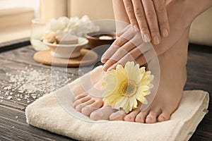 Young woman with beautiful pedicure and manicure after treatment in spa salon, closeup