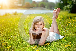 Young woman with a beautiful smile with healthy teeth with flowers. Face of a beautiful positive girl Concept on the subject