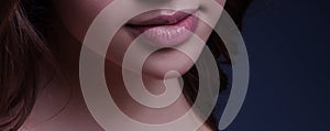 Young woman, Beauty pink lip makeup detail.Macro of woman`s face part.Chubby lips with pink lipstick show a fashionable make-up an