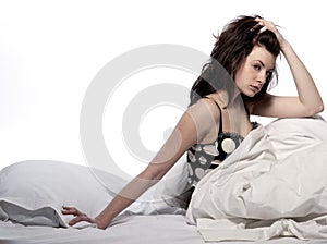 Young woman in bed awakening hangover