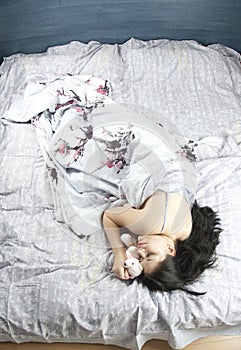 Young woman in bed sleeping and dreaming