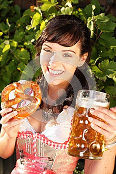 Young woman with beer glasses and bretzel photo
