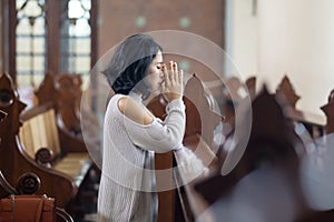 Young woman begging forgiveness in church