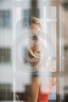 Young woman behind window