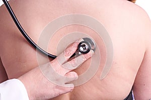 Young woman being exam for pneumonia by her family doctor photo