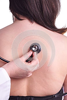 Young woman being exam for pneumonia by her family doctor