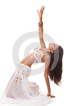 Young woman belly dancer in white costume