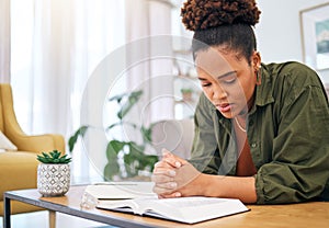 Young woman, bible and prayer in home, desk and mindfulness for faith, religion and reading with hope for future