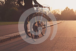 Young woman with bicycle in the park