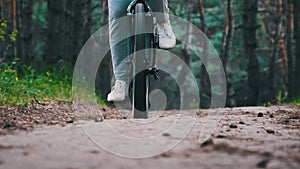 Young Woman on a Bicycle Rides Along a Forest Path in Summer Day, Slow Motion