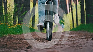Young Woman on a Bicycle Rides Along a Forest Path in Summer Day, Slow Motion