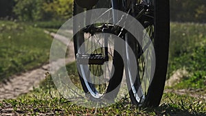 Young Woman on Bicycle Rides Along Green Forest Path in Summer Day, Slow Motion