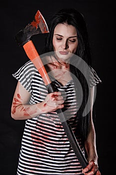 Young woman with a big bloody axe