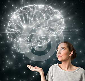 Young woman with big glowing brain
