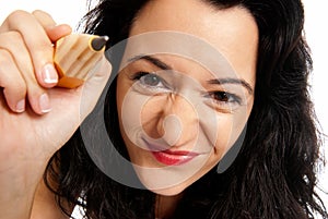 Young woman with big pencil draw camera isolated