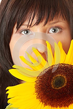 Young woman with a big sun flower