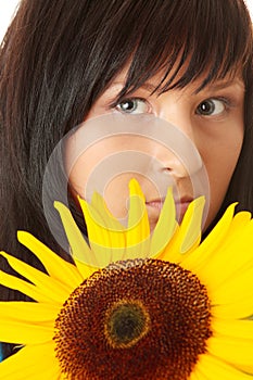 Young woman with a big sun flower