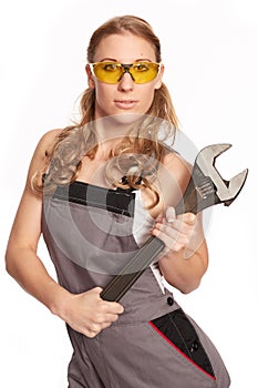 Young woman with a big wrench