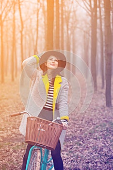 Young woman with bike at outdoor countryside.