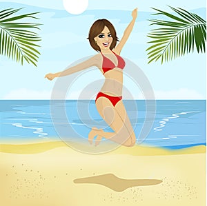 Young woman in bikini jumping in the air on tropical beach
