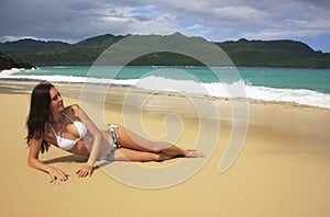 Young woman in bikini laying at Rincon beach, Samana peninsula photo