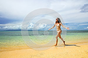 Young woman in bikini running on the beach, Taveuni Island, Fiji