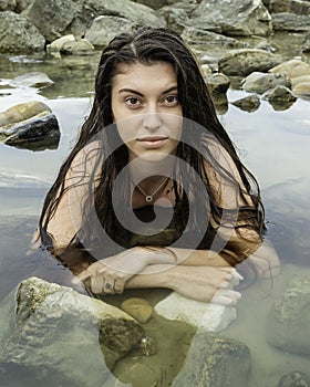 Young woman in bikini by the sea, portrait of a sexy girl on the beach