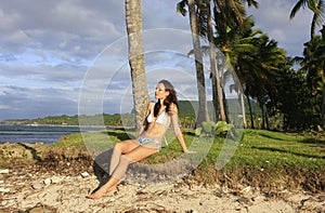 Young woman in bikini sitting at Las Galeras beach, Samana peninsula photo