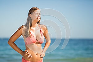 Young woman in bikini standing on beach