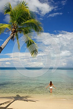 Young woman in bikini standing in clear water, Nananu-i-Ra island, Fiji