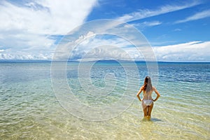 Young woman in bikini standing in clear water on Taveuni Island, Fiji